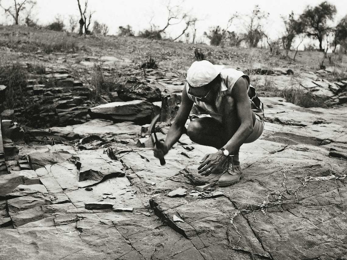 Géologue échantillonnant un affleurement de quartzite en Mauritanie, vers 1960